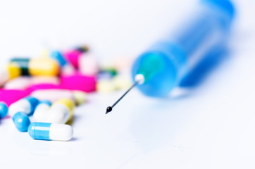 Medical equipment. Injection isolated on a white background with reflection and pills. Pharmacy...