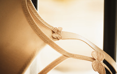 A bra hangs over a metal bed - passion or loneliness?