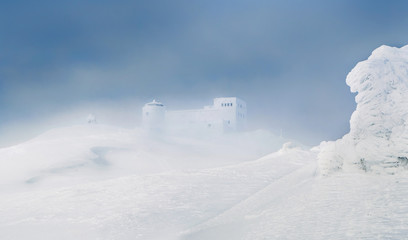 Beautiful winter landscape with snowy hills and abandoned observatory