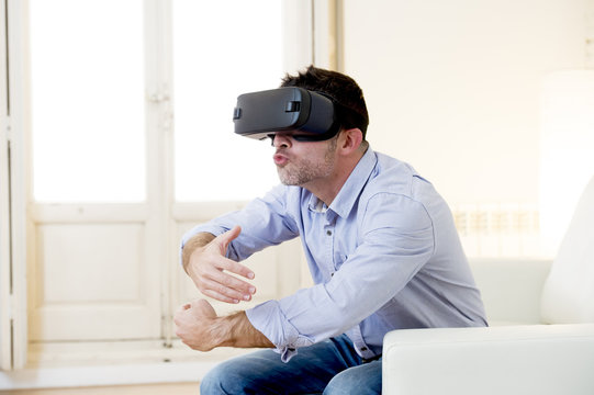 happy man at home living room sofa couch excited using 3d goggles watching 360 virtual reality