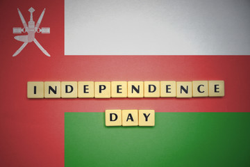 letters with text independence day on the national flag of oman.