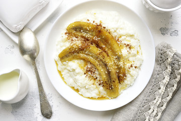 Rice porridge with coconut milk,caramelized banana and cinnamon.Top view.
