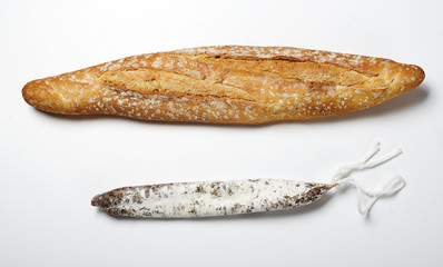 Bread and fuet on white background. Spanish sausage. Isolated.
