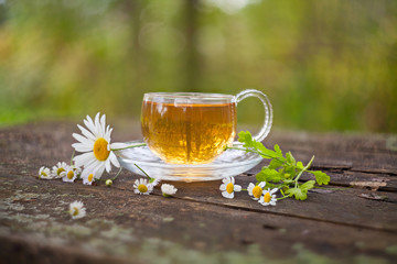 Crystal cup with green tea on table