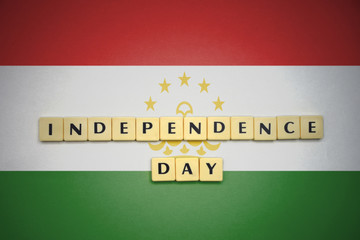 letters with text independence day on the national flag of tajikistan.