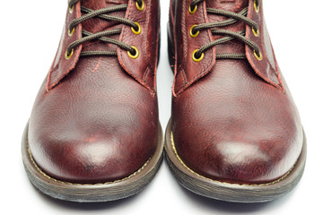 Stylish brown leather boots for men isolated on white background, close-up view.