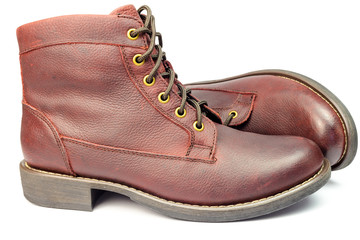 Stylish brown leather boots for men isolated on white background.