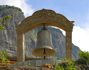 Obraz premium Large bell covered with written, at the foot of the peak of Adam