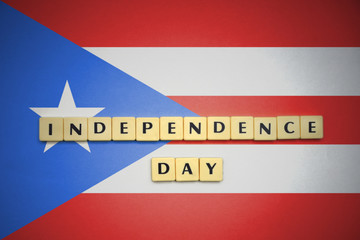 letters with text independence day on the national flag of puerto rico.