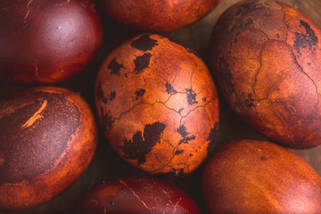 Easter eggs on wooden background. Painted brown with spots and cracks