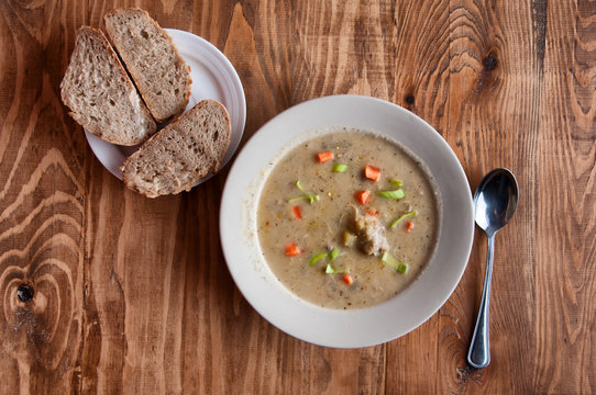 Grandma's soup with a spoon and bread