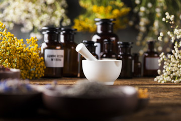 Herbs medicine,Natural remedy and mortar on vintage wooden desk background