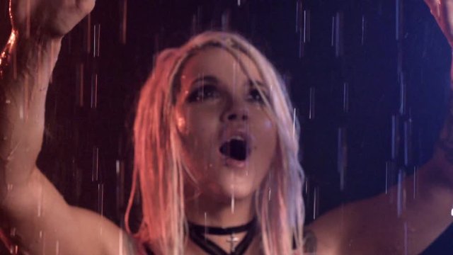 sexy attractive blonde girl in a pink top and a sword belt shouts and sings in the rain. suffering. unrequited love. Music clip. sloumotion. closeup. anime.