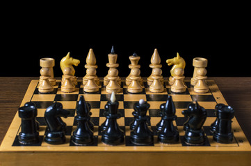 game of chess figures stand on the positions of, isolated black background