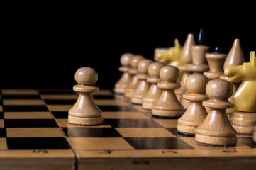 the game of chess, the first move a pawn, isolated black background