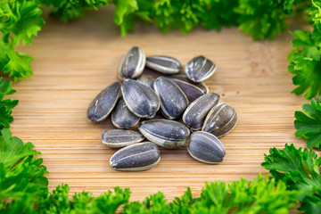 Sunflower seeds and Parsley on wood