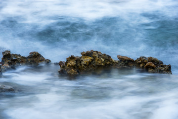 blurred waves on a rocky sea coast