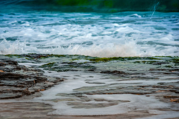 waves crushing into a rocky sea coast