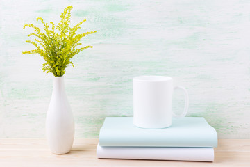 White coffee mug mockup with ornamental green flowering grass