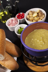 Cheese fondue with pesto sauce.