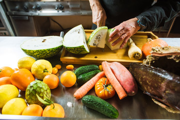 Close-up of male hands cutting white watermelon