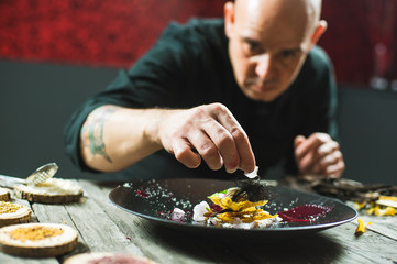 Chef is concentrated on preparing molecular dish