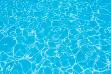 Beautiful ripple water surface with sun reflection in swimming pool