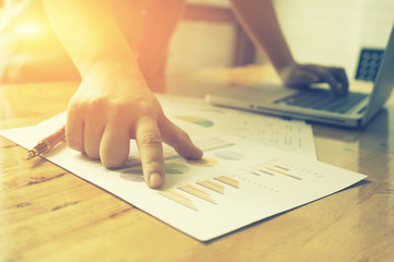 male hand pointing at business document,discussion at meeting,business graphs indicating corporate progress,discussing the charts and graphs showing the results  successful teamwork,selective focus