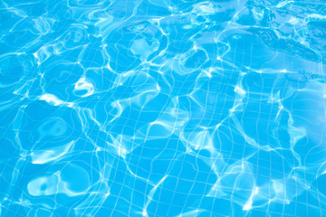 Fototapeta na wymiar Blue and bright ripple water and surface in swimming pool , Beautiful motion gentle wave in pool.