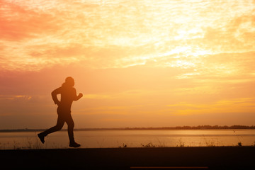 Fototapeta na wymiar Silhouette man relaxing by running