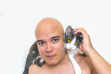 A man with a cute cat on his shoulder
