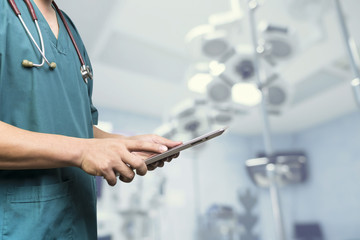 Male doctor,medical students or surgeon using digital tablet and laptop during the conference,Health Check with digital system support for patient,test results and patient registration,selective focus