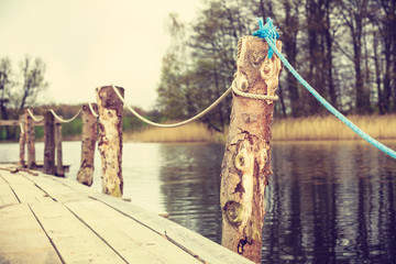 Old wooden pier on lake shore