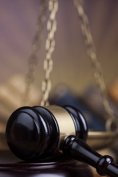 Law theme, mallet of the judge, wooden desk background