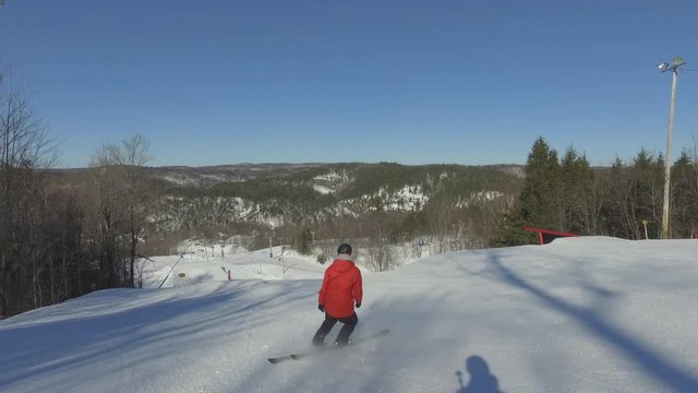 Pro Skier does grind on handrail-tricks filmed from behind