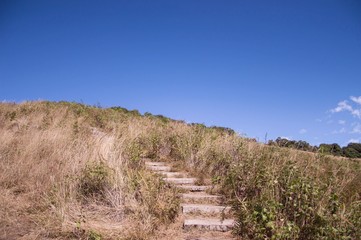 Walkway on hill at the mountain with blue sky