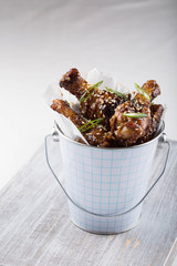 Chicken wings served in a metal pail. Bar food. 