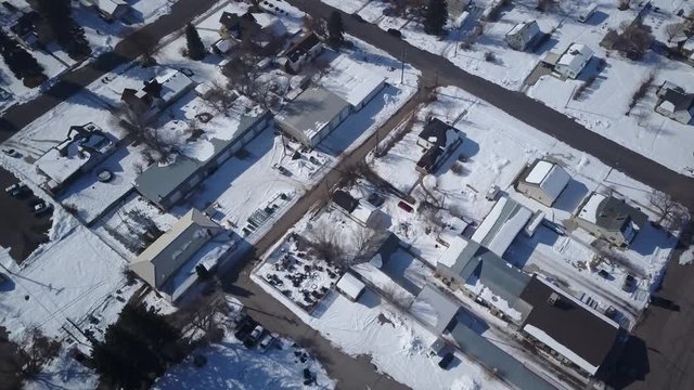 Aerial Ephraim Utah rural city homes roads winter snow drone. Surveillance spy. Storm blizzard fresh white snow. Rural farm community. Hard seasonal weather. Hazard to driving. Surveillance spy.