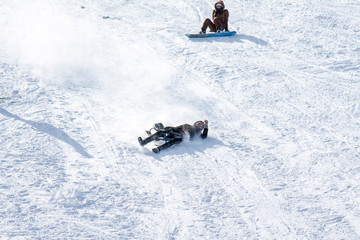 skiing on a snowy hill on a sled