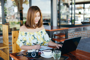 woman using laptop in cafe