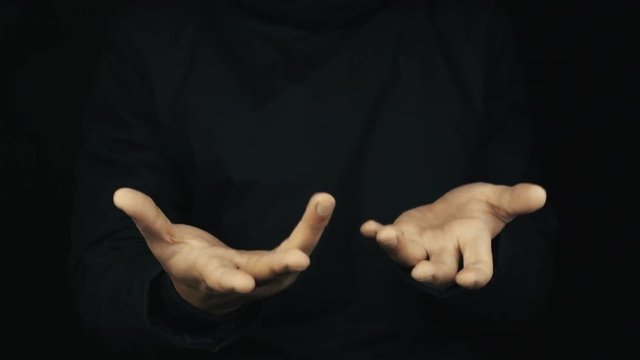 Caucasian male hand in long sleeve jacket open palms stopping and italian stereotype gestures on black backround, close up isolated