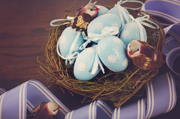 Easter birds nest with blue eggs.