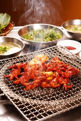 Spicy chicken feet on grill