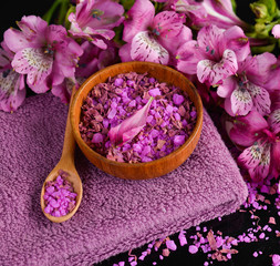 Obraz na płótnie Canvas Spa background-towel, orchid, and spoon ,petals in bowl, salt in spoon