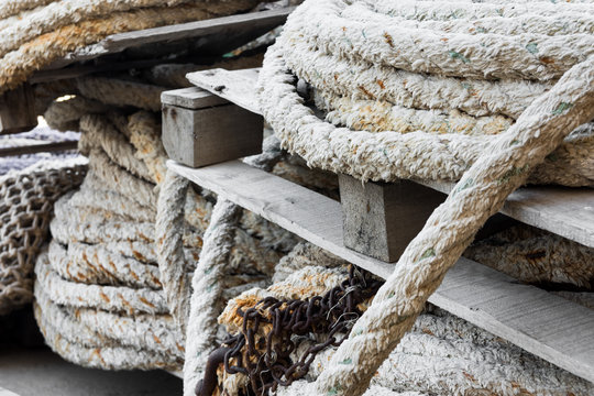 Stack of rolled mooring ropes on timber pallets in a fishing port, close up, Mediterranean sea, Costa Blanca, Spain