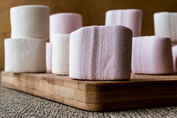 Stack of Marshmallows on wooden surface.