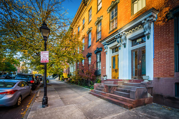 Autumn color and houses along Stricker Street, at Union Square, in Baltimore, Maryland.