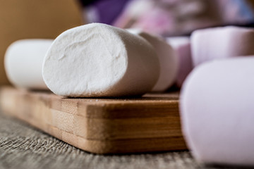 Stack of Marshmallows on wooden surface.