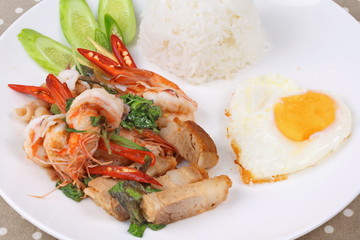 Jasmine rice topped stir - fried spicy basil with meat.