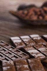 Dark and milk chocolate bar on a wooden table